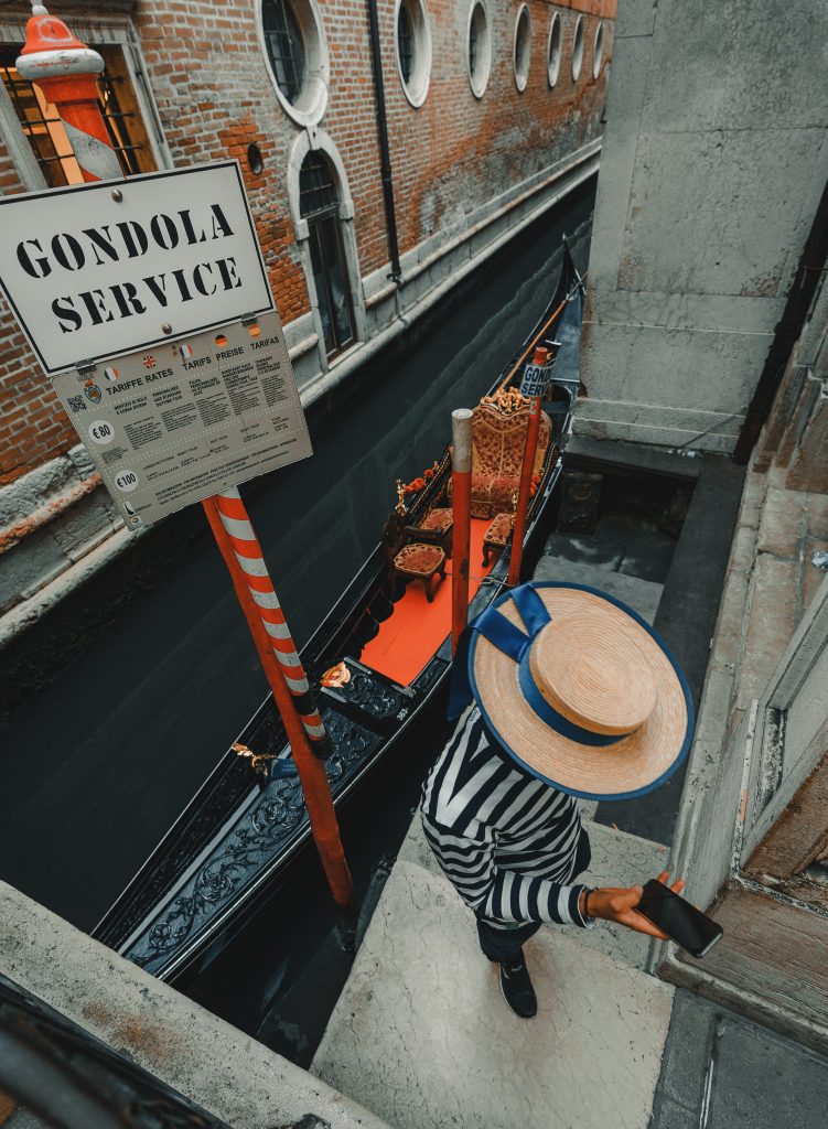 Venice Gondolier wearing a boater hat, photo by Clay Banks